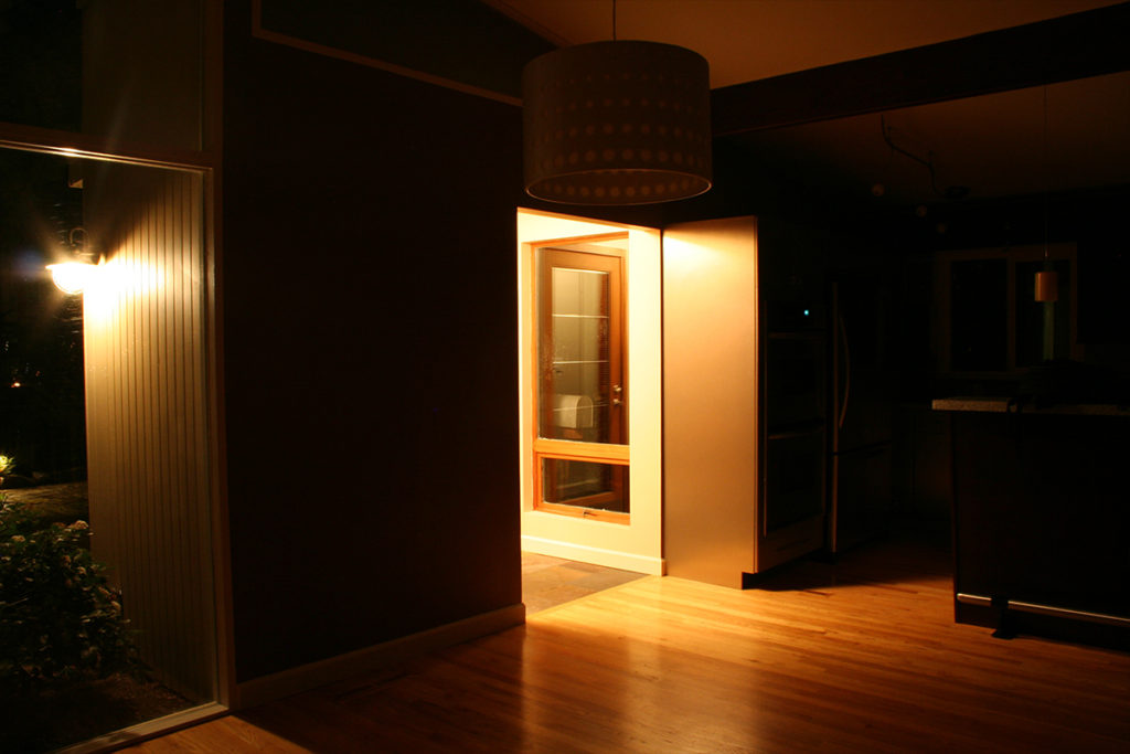 A lit doorway in a dark wall